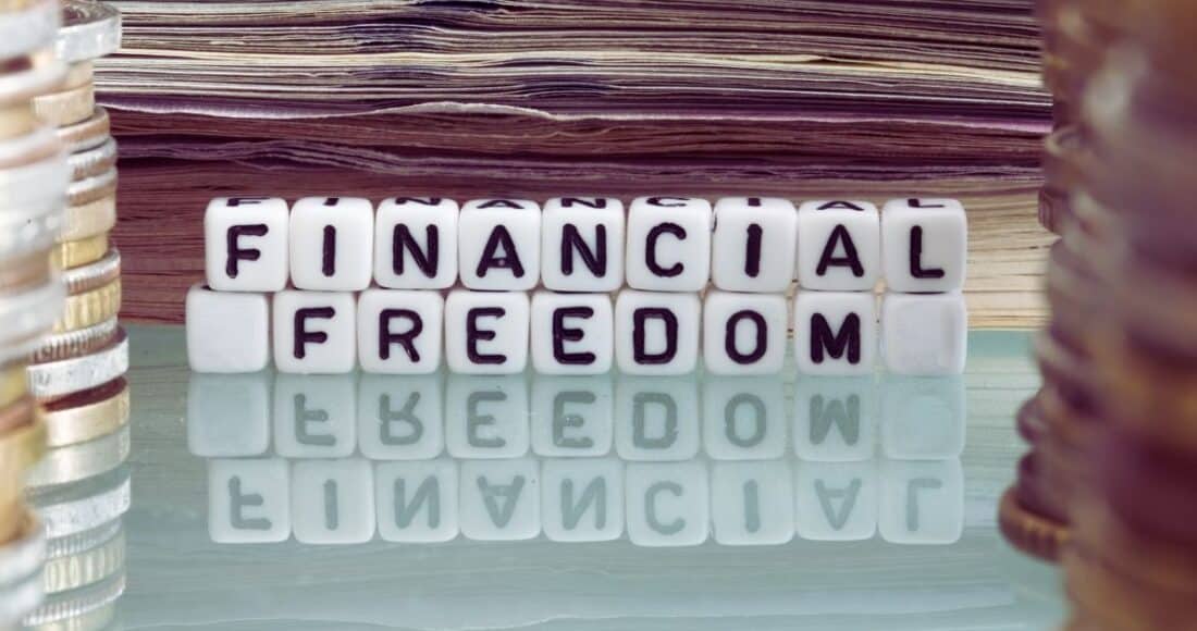 Financial freedom spelled out with blocks surrounded by money