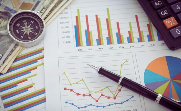 Graphs and a stack of cash representing financial independence